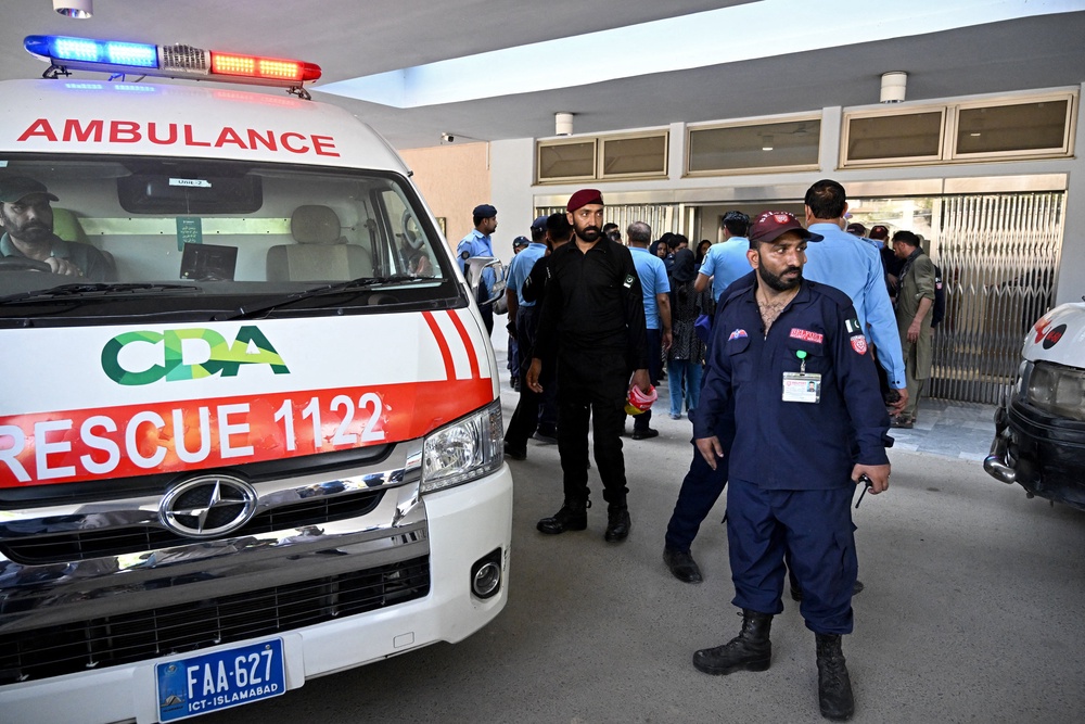 Security personnel stand next to an ambulance following a fire incident outside the Mother and Child Health (MCH) ward at the Pakistan Institute of Medical Sciences (PIMS) Hospital (AFP/Getty)
