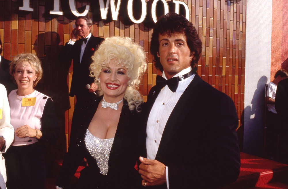 Sylvester Stallone and Dolly Parton at the Rhinestone premiere in 1984 (Alamy/PA)