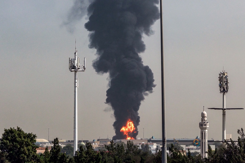 A smoke plume rises from an ongoing fire near Dubai International Airport in Dubai on March 16 (AFP/Getty)