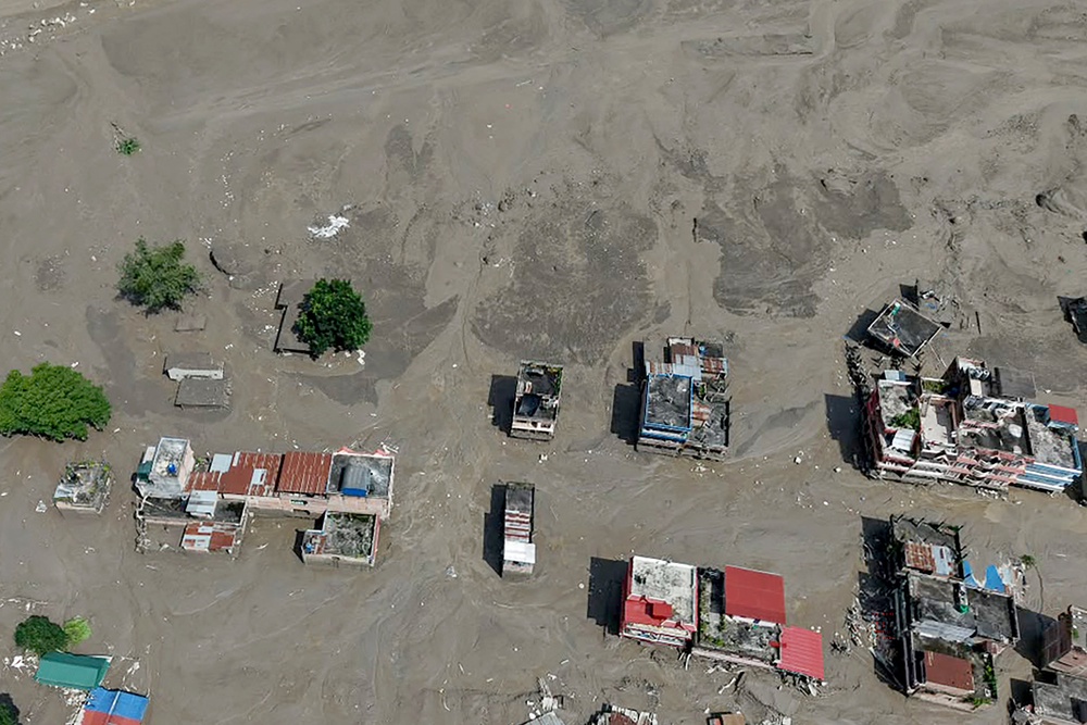 Houses lie partially submerged in muddy water along a riverside after flash floods at Trishuli Bazar (AFP/Getty)