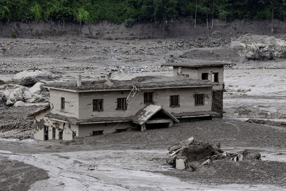 A mud-covered building following a flash flood at Trishuli in Nuwakot district, Nepal (Reuters)