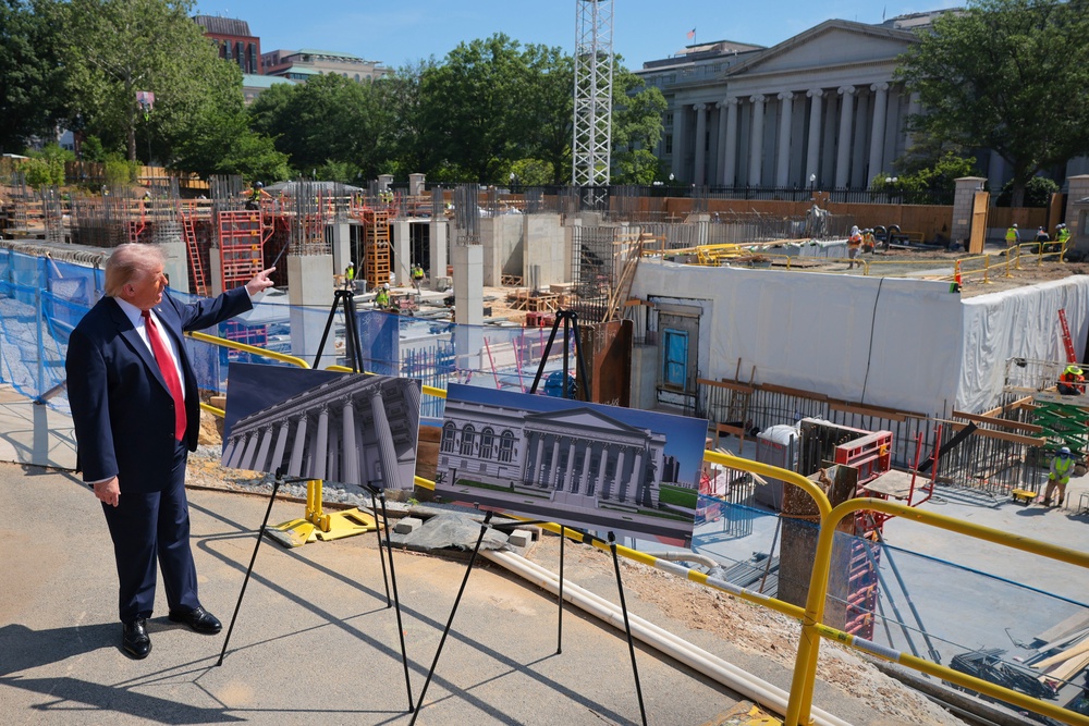 President Donald Trump speaks to the media alongside posters of his proposed White House ballroom amid construction at the White House May 19 (Getty Images)