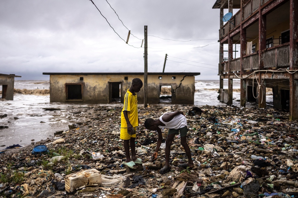 Children inspect debris washed ashore in Ayetoro, in Nigeria's Ondo State, where coastal erosion since the 2000s has gradually swallowed homes, schools, and other infrastructure (AFP/Getty)