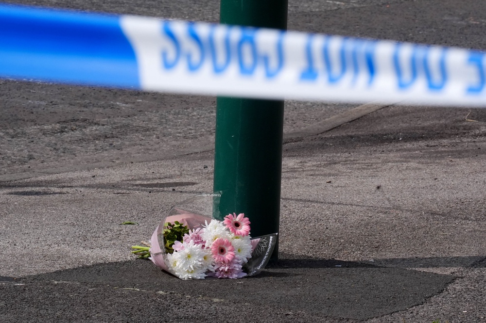 A floral tribute left near the scene, where a murder investigation has been launched (Owen Humphreys/PA) (PA Wire)