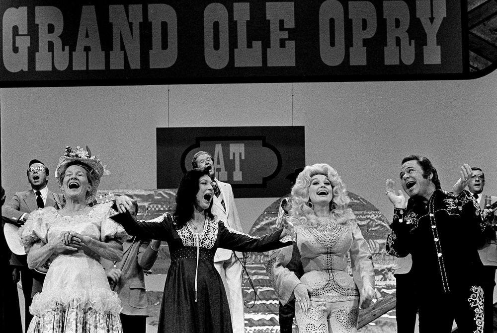 Minnie Pearl, Loretta Lynn, Dolly Parton, and Roy Clark acknowledge applause after singing a song together during the end of the taping of 'The Grand Ole Opry at 50, A Nashville Celebration' (Reuters)
