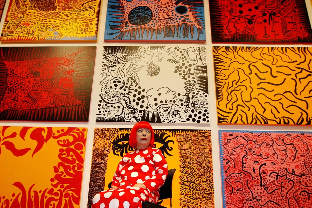 Artist Yayoi Kusama with her artwork ‘Love arrives at the Earth Carrying with it a Tale of the Cosmos’ at the Tate Modern gallery in 2012 (Reuters)