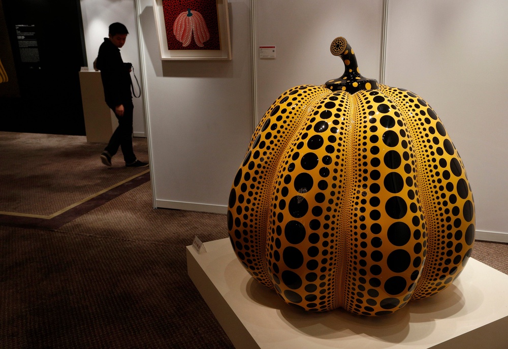 A man walks past a work ‘Pumpkin’ by Yayoi Kusama. (Copyright 2026 The Associated Press. All rights reserved.)