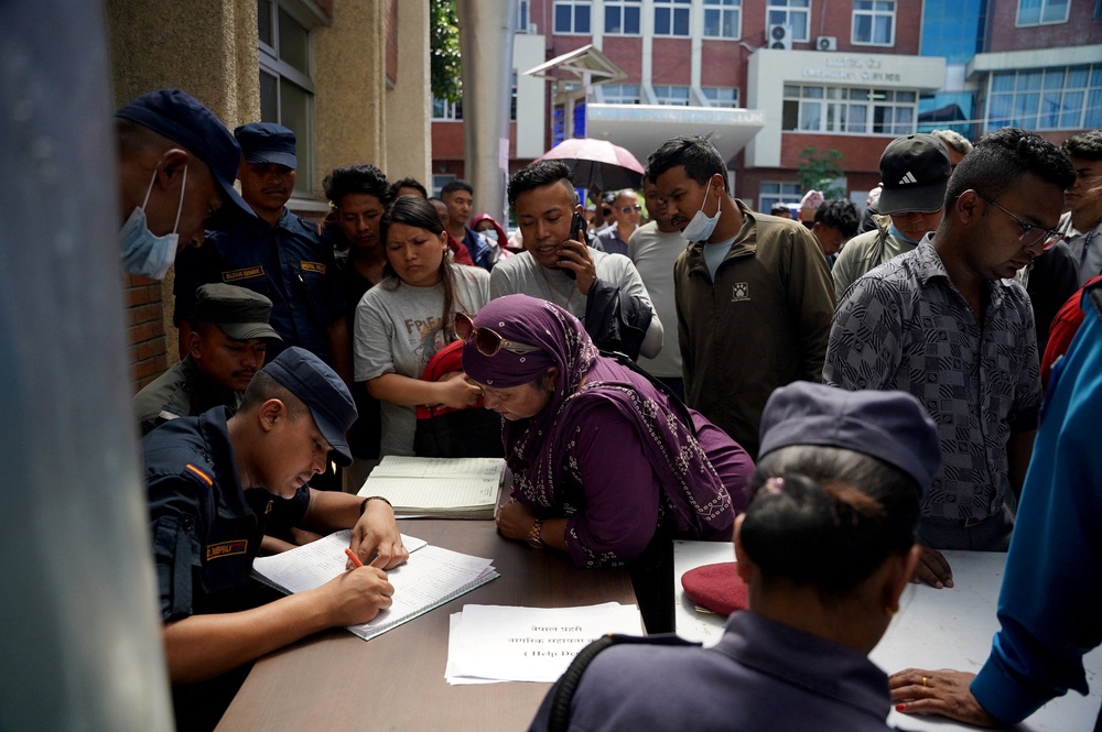 Family members gather in a hospital to check list of injured people following deadly floods, in Kathmandu, Nepal, 27 August 2026 (Reuters)