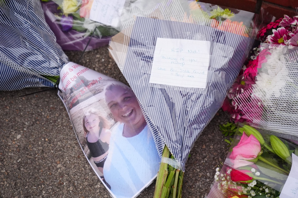 Flowers left near the scene of the fire on Thursday (PA)
