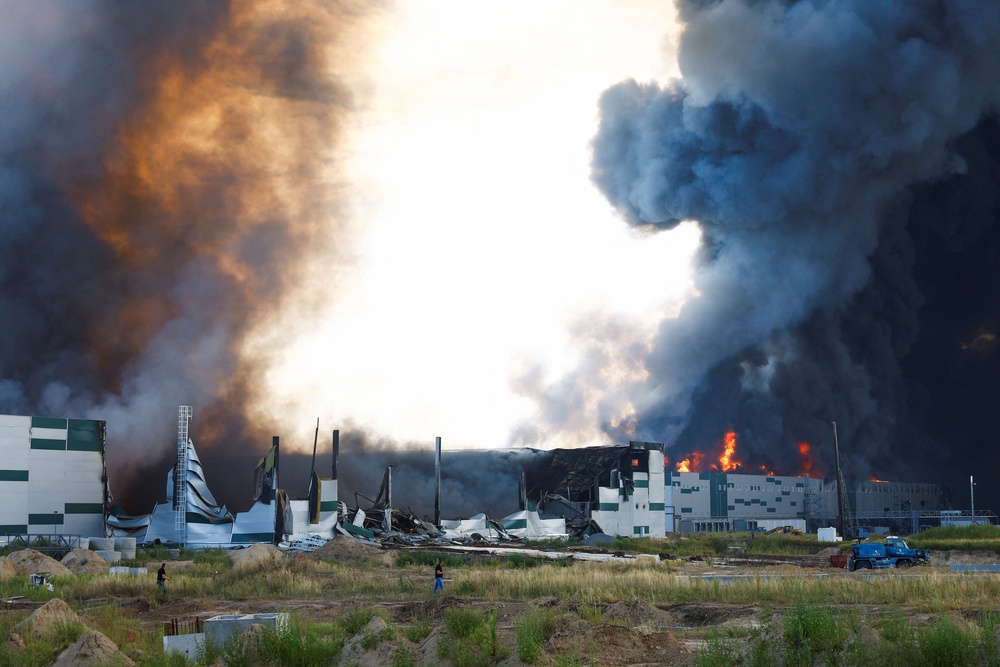Smoke rises over a warehouse, which was hit by a Russian drone strike, amid Russia's attack on Ukraine, in Kyiv region, Ukraine, August 27, 2026. (Reuters)
