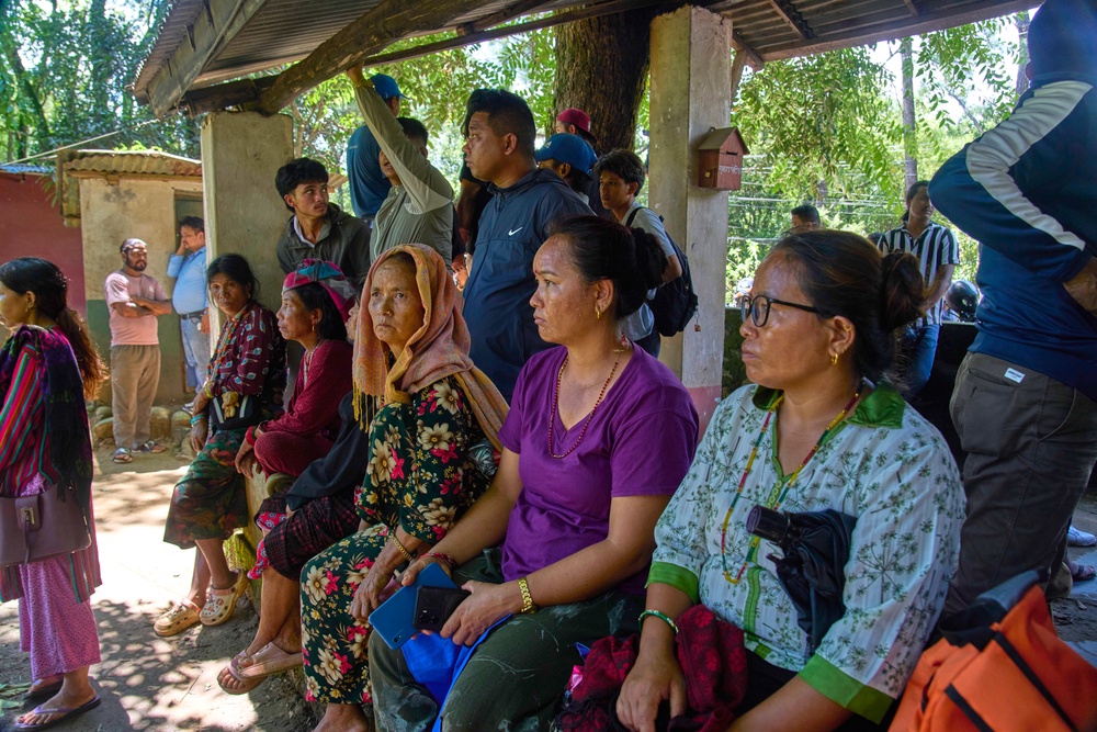 Residents wait for news of their relatives missing after flash floods in Bidur, Nepal’s Nuwakot district (Niranjan Shrestha/AP) (AP)