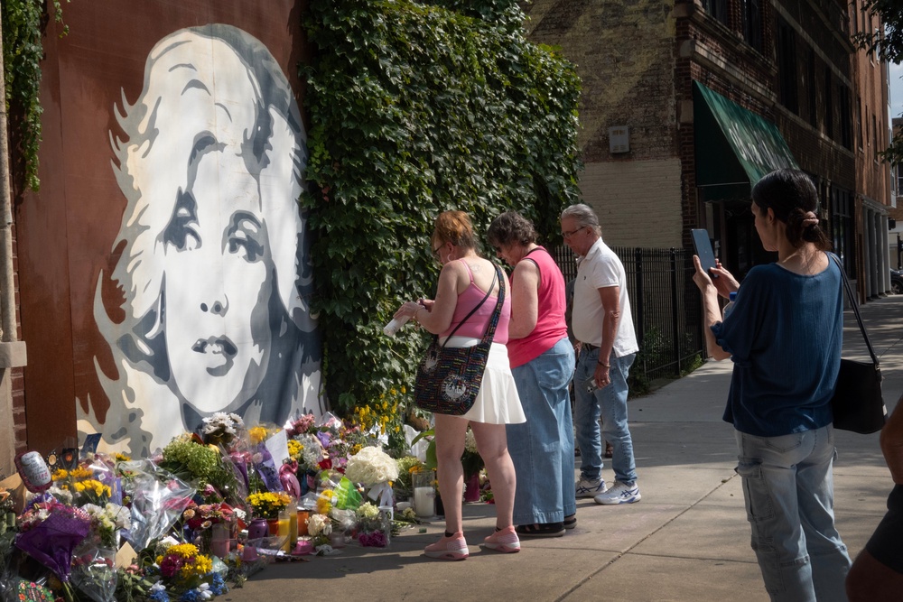 Parton fans visit a mural featuring her likeness in Chicago on Wednesday (Getty Images)