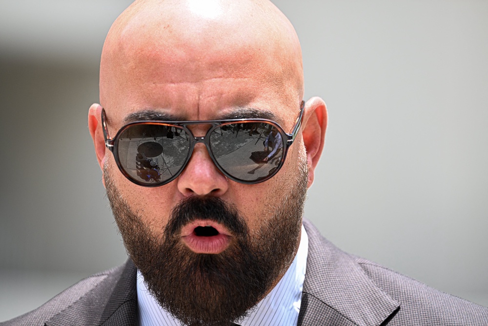 Joseph D. McBride, attorney for Andrew Tate and Tristan Tate, speaks to the press following an extradition hearing for the Tate brothers at the C. Clyde Atkins US Courthouse in Miami, Florida, on July 27 (AFP/Getty)