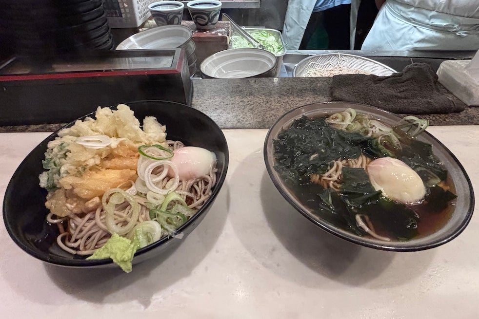 Ellie tucks into soup and noodles at one of Omoide Yokocho’s no-frills ramen bars (Ellie Seymour)