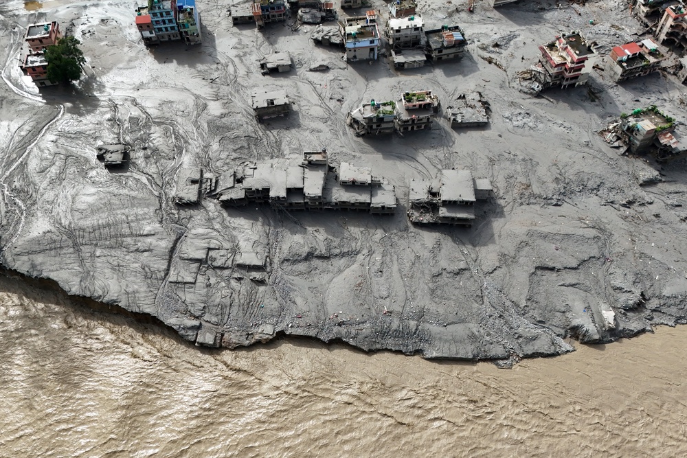 Mud covers buildings in Trishuli (Reuters)