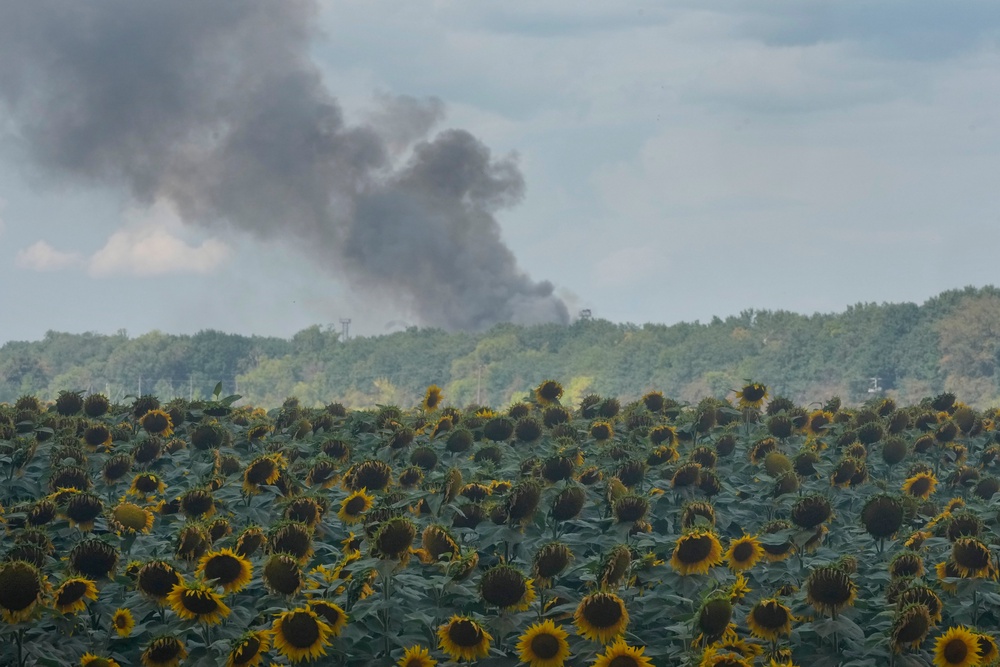 Smoke rises above warehouse stores behind a sunflower field following a Russian air attack in Kyiv, Ukraine, Thursday, Aug. 27, 2026. (AP)