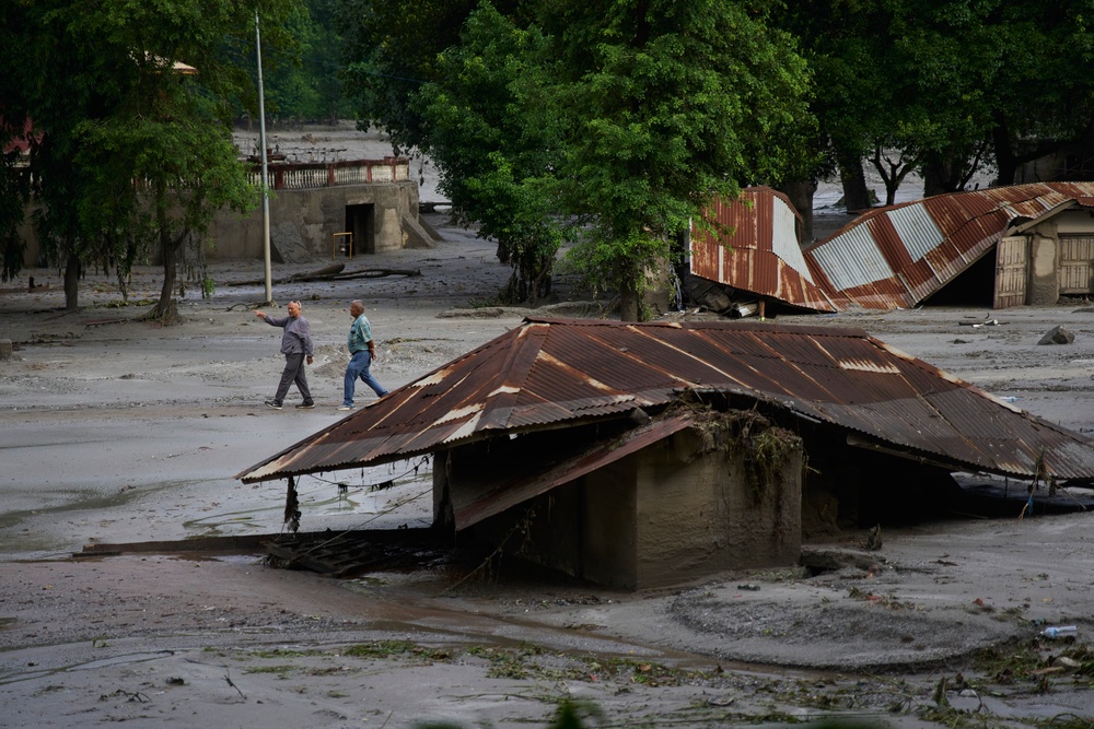People walk amid damage in the aftermath of flash floods in Devighat in the Nuwakot district of Nepal (Niranjan Shrestha/AP) (AP)