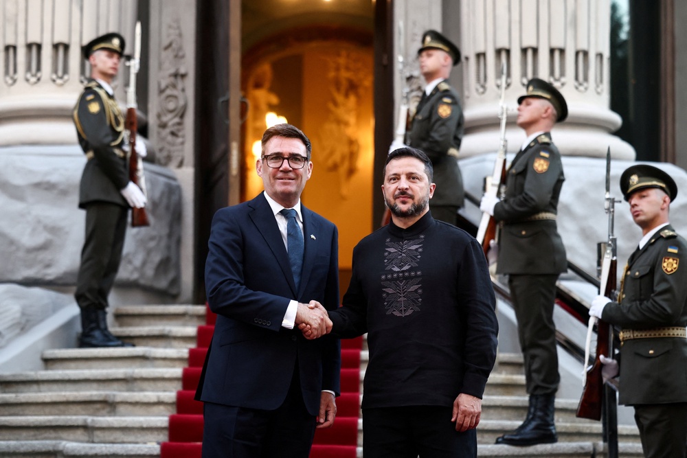 Ukraine's President Volodymyr Zelensky welcomes and shakes hands with British Prime Minister Andy Burnham in Kyiv (Reuters)