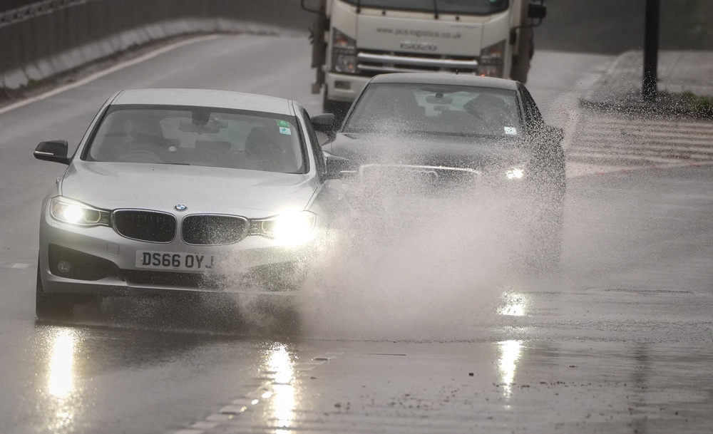 Cars drive through rain on the A3 (Aaron Chown/PA) (PA Archive)