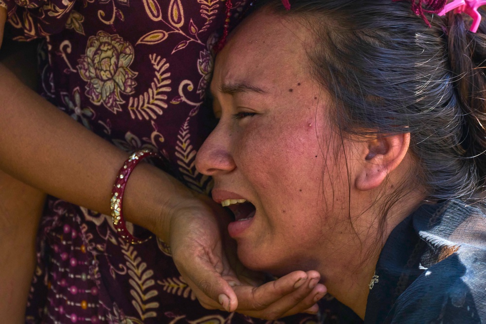 A girl in Bidur, Nuwakot district, waits for news of relatives (AP)