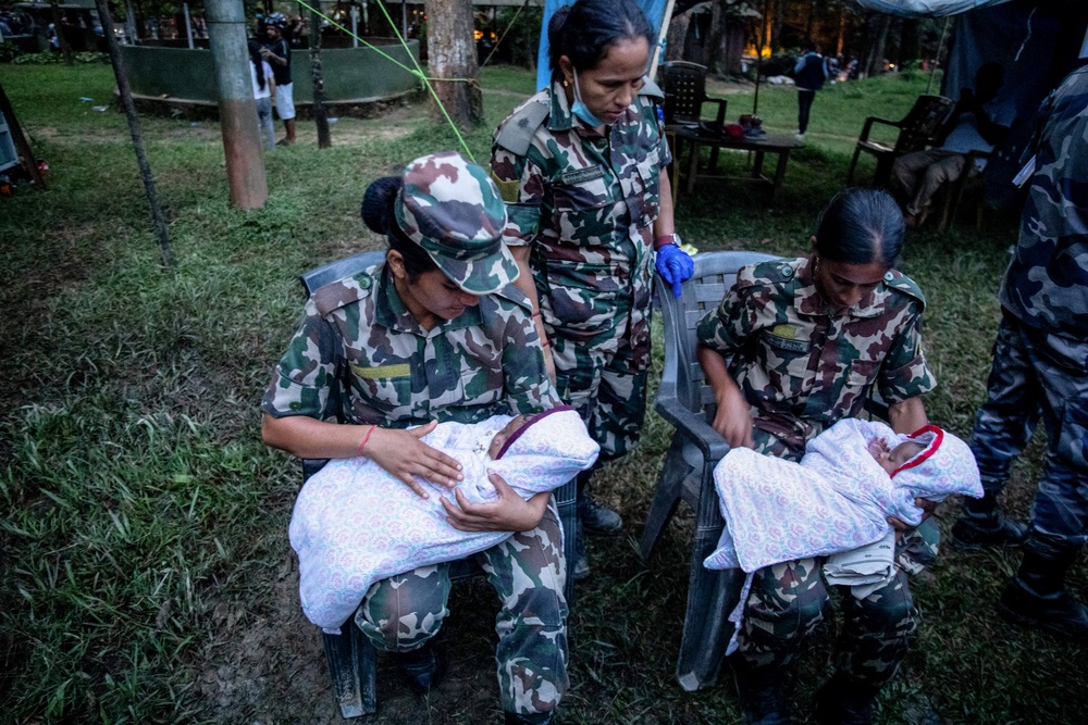 Nepali soldiers comfort twin infants during rescue operations (AFP/Getty)