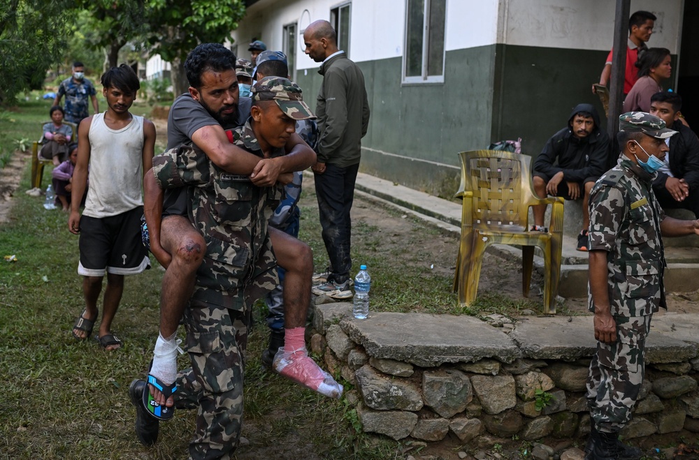 Army and rescue personnel carry a flood victim to treatment at an army rescue camp in Trishuli Batar, Nepal (Getty)