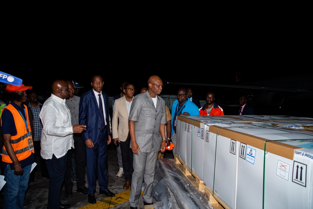In this photo released by UNICEF, officials inspect doses of Ebola (Zaire) vaccines upon arrival at Ndjili International Airport in Kinshasa, Congo. (Ndomba Mbikayi/UNICEF via AP)