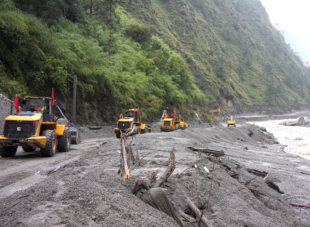 Rescue workers repair a road leading to Gyirong Port after a mudslide (Reuters)