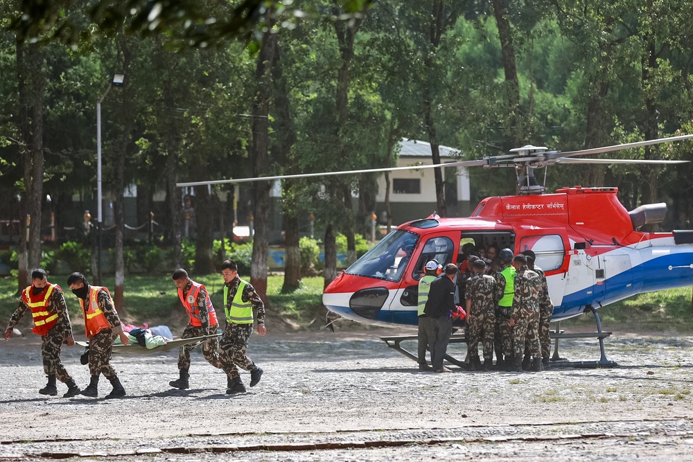 Army personnel carry a rescued resident at an army camp following flash floods in Battar Bazar town of Nepal's Nuwakot district on August 28, 2026 (AFP/Getty)