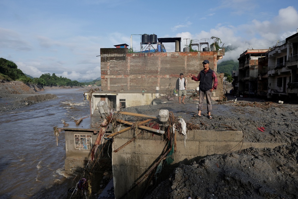 A man stands amid the debris of a house following flash floods and a mudslide in Trishuli, Nuwakot district, Nepal, August 28, 2026 (Reuters)