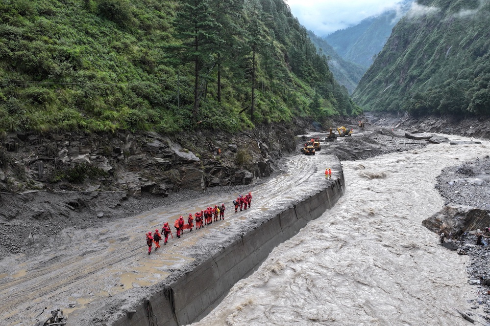 A drone view of firefighters conducting search and rescue operations at a damaged road leading to Gyirong Port after a mudslide, in Gyirong county, Shigatse, Tibet Autonomous Region, China (Reuters)