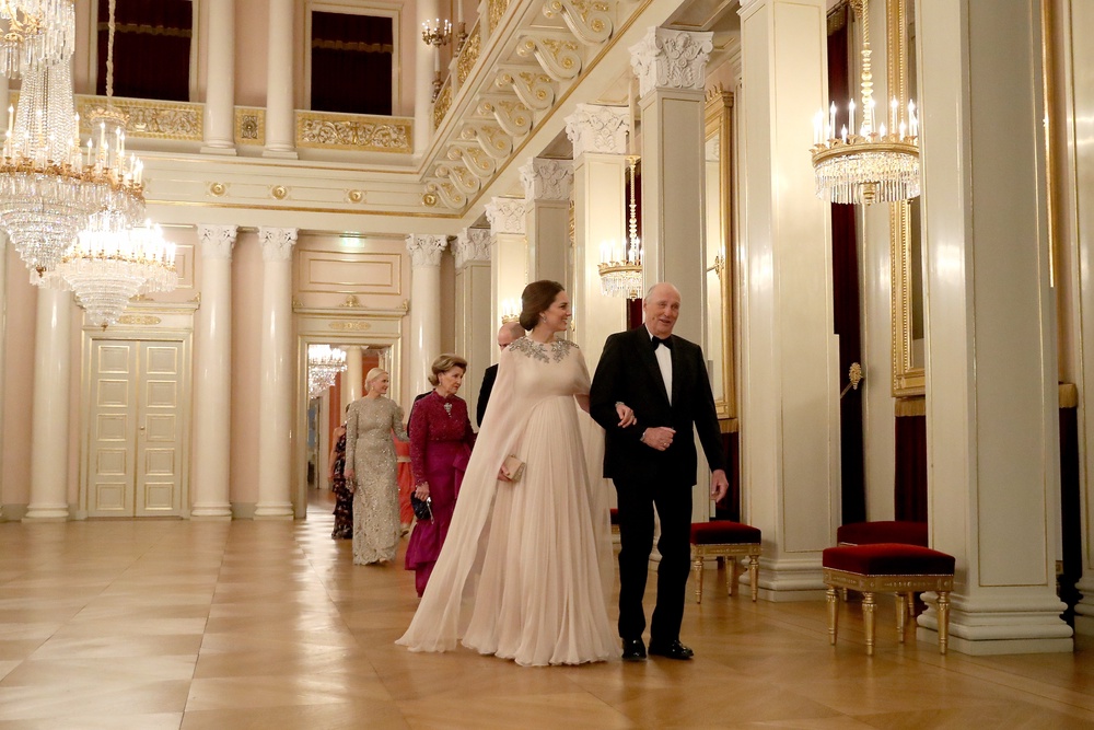 King Harald escorts Catherine, then the Duchess of Cambridge, to dinner in Oslo in 2018 (PA)