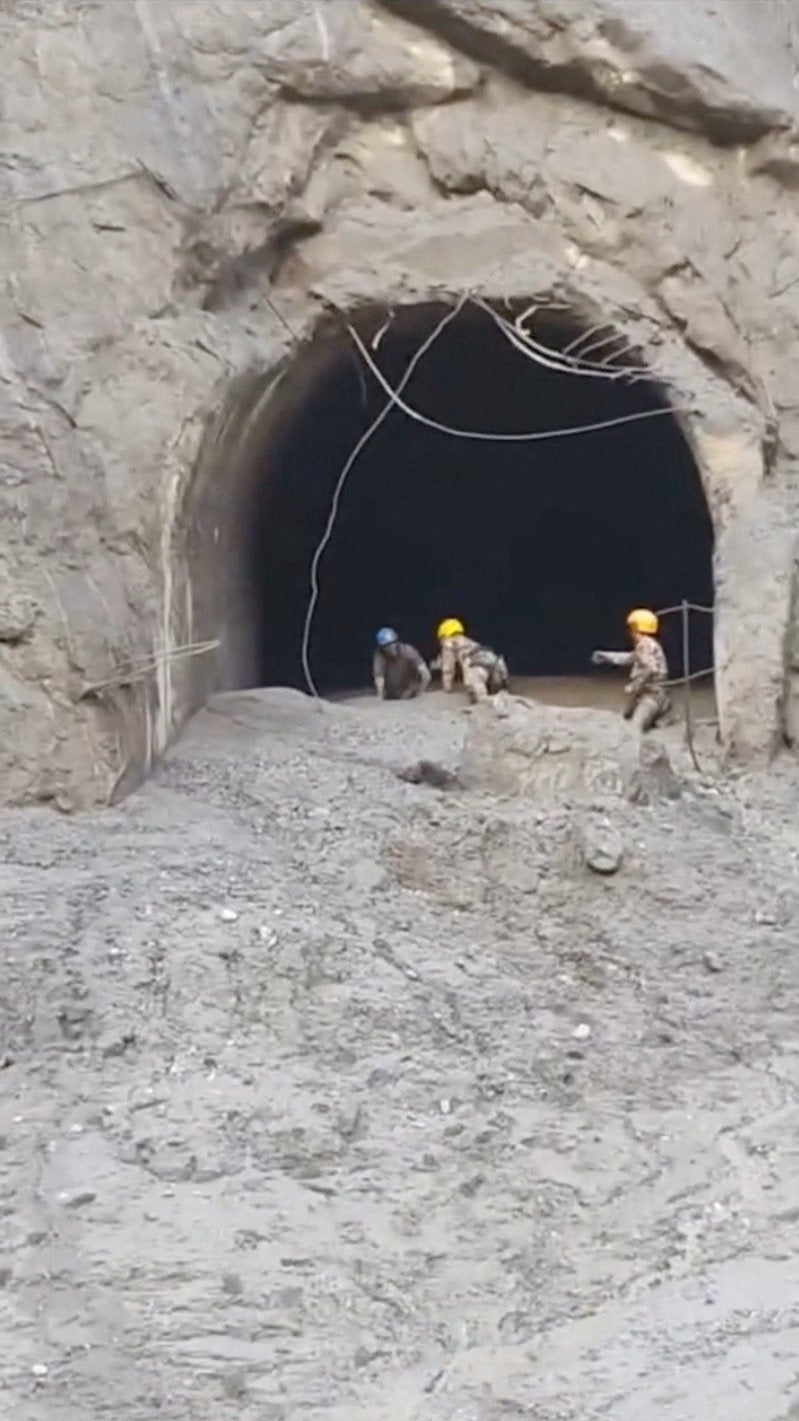 Rescuers evacuate a person from a tunnel of a hydropower project, in the aftermath of flash floods and a mudslide, in Rasuwa, Nepal (Reuters)