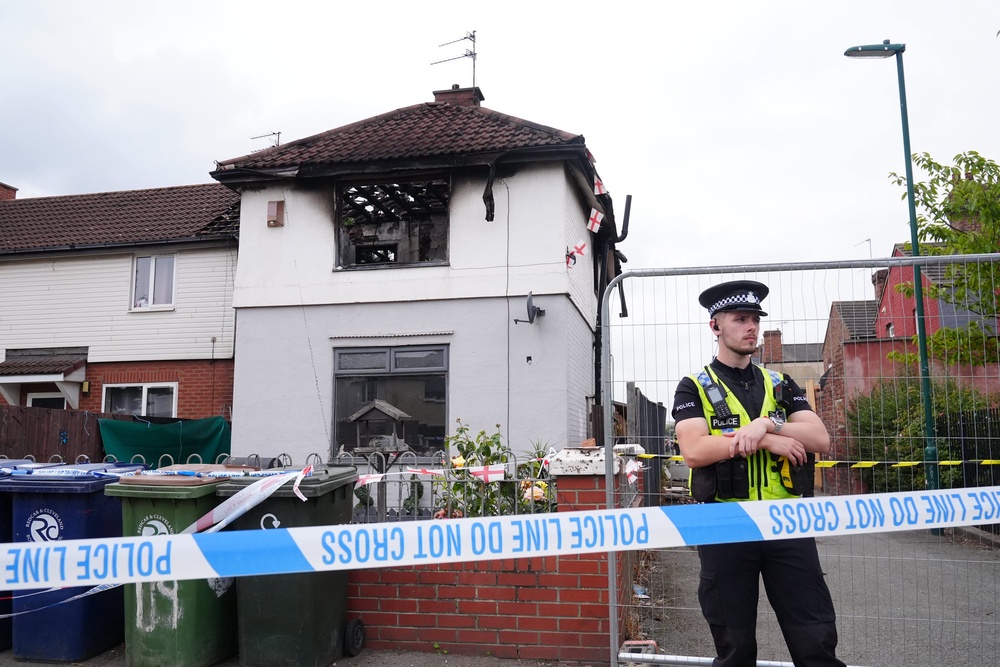 Police officers at the scene on Birchington Avenue, Grangetown, near Middlesbrough, where Valentina Foster, aged seven, and Natalie McDonald, 34, died following a fire (Owen Humphreys/PA) (PA Wire)