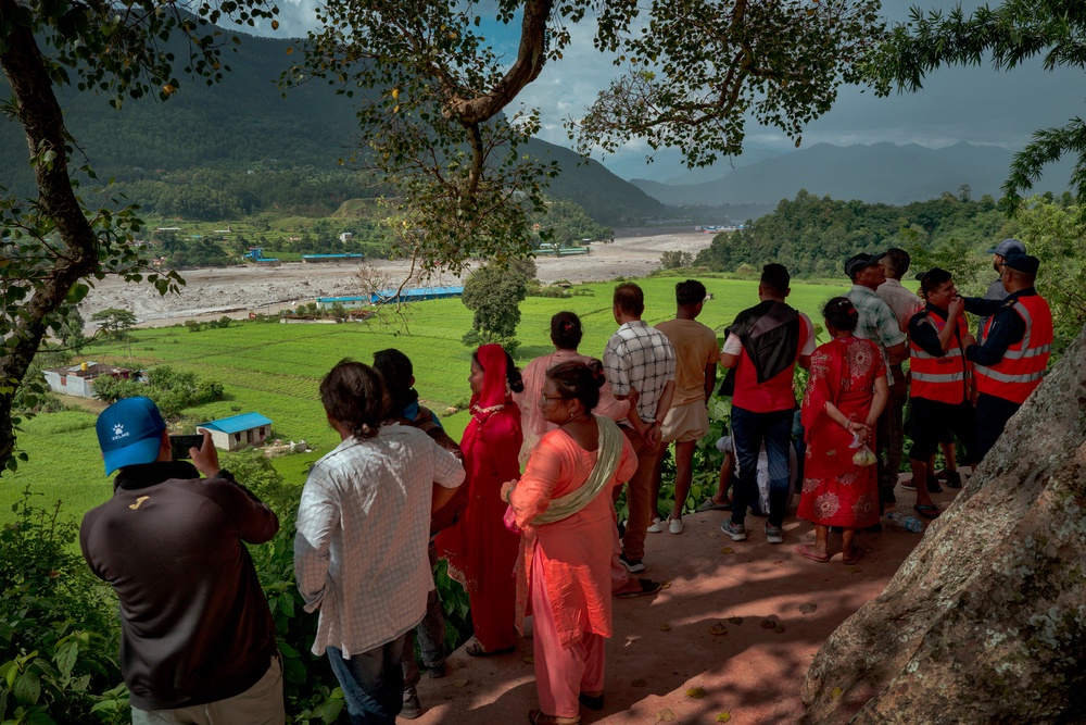Residents view the Trishuli river from a hilltop after police alerted them of another possible surge on 28 August 2026 (Getty)