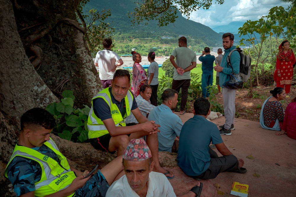 Residents view the Trishuli river from a hilltop after police alerted them of another possible surge on 28 August 2026 (Getty)