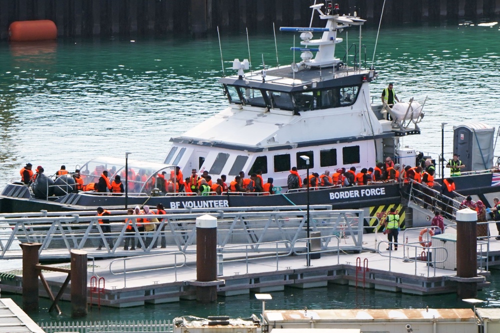 A group of people thought to be migrants are brought into the Border Security Command compound in Dover, Kent, on Thursday (Gareth Fuller/PA) (PA Wire)