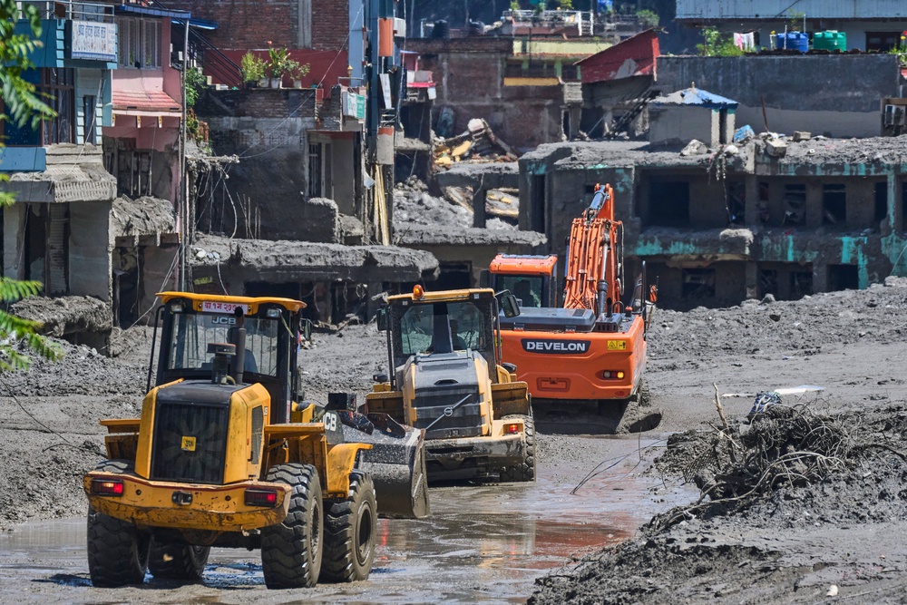 Earthmovers clear the debris of flash flooding in Nepal’s Nuwakot district (Niranjan Shrestha/AP) (AP)