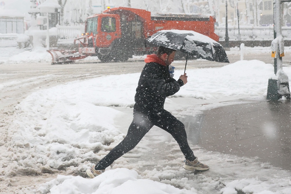 People walk in a blizzard in New York City in February. The Northeast is forecast to see snow and cooler temperatures again (Getty)