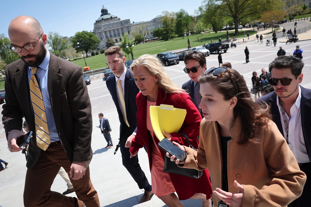 Milo Yiannopoulos (pictured right) is known for working for people aligned with far-right politics; for example, he interned with former Rep. Marjorie Taylor Greene (pictured center) (Getty)