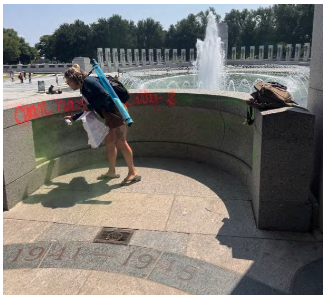 A witness took a photo of the woman defacing the memorial, according to the DOJ (DOJ)