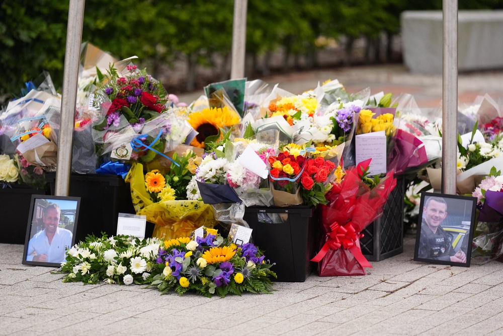 People left floral tributes to Pc Clough and Pc Blades at the Cleveland Police HQ in Middlesbrough (Owen Humphreys/PA) (PA Wire)
