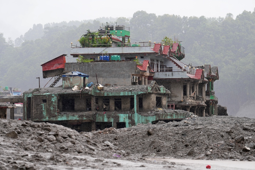 A damaged house stands amid debris of flash flooding in Nuwakot district in Nepal on Saturday (Rajesh Kumar Singh/AP) (AP)