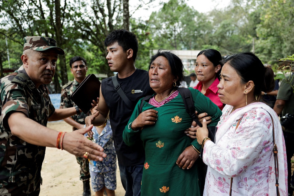 A woman is consoled as she arrives at Maithili Barrack, an army training centre which serves as a primary base to airlift survivors from Rasuwa district, following flash floods and a mudslide, in Trishuli, Nuwakot district, Nepal, August 28, 2026. (Reuters)