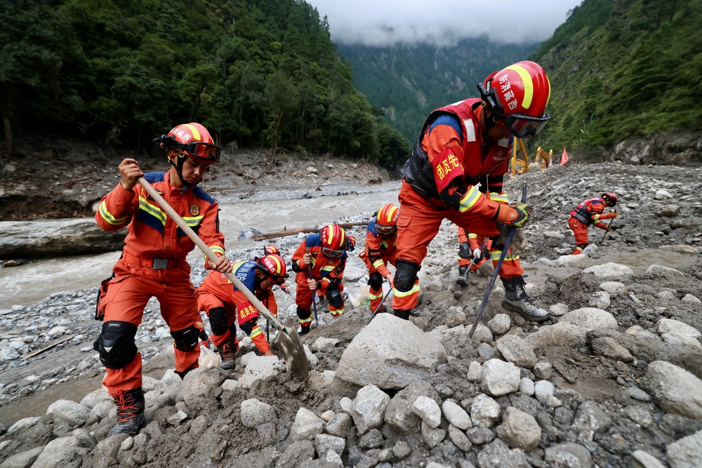 Rescue workers clear debris during search operations near the Gyirong port after a mudslide, in Shigatse, Tibet Autonomous Region, China August 29, 2026. (Reuters)