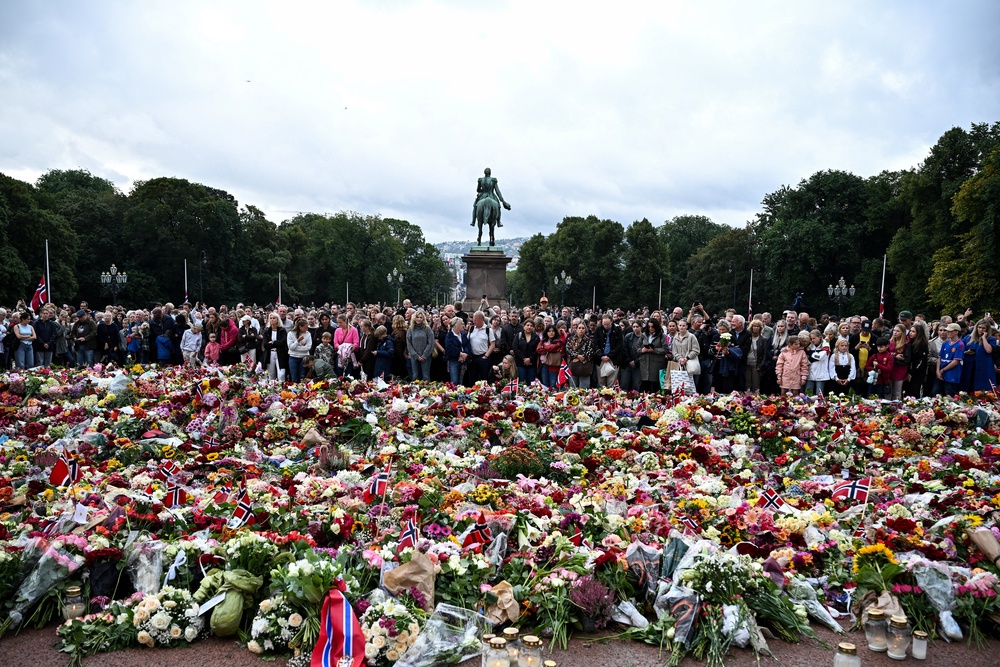 People gather to pay their respects outside the Royal Palace, following the death of Norway's King Harald (Reuters)