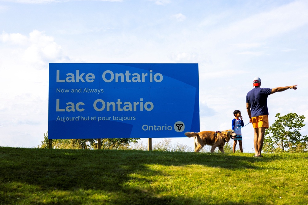 A family walks by a sign reading 