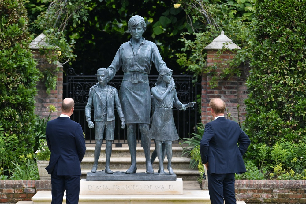 The then-Duke of Cambridge and Duke of Sussex look at the statue they commissioned of their mother in the Sunken Garden at Kensington Palace in 2021 (Dominic Lipinski/PA)