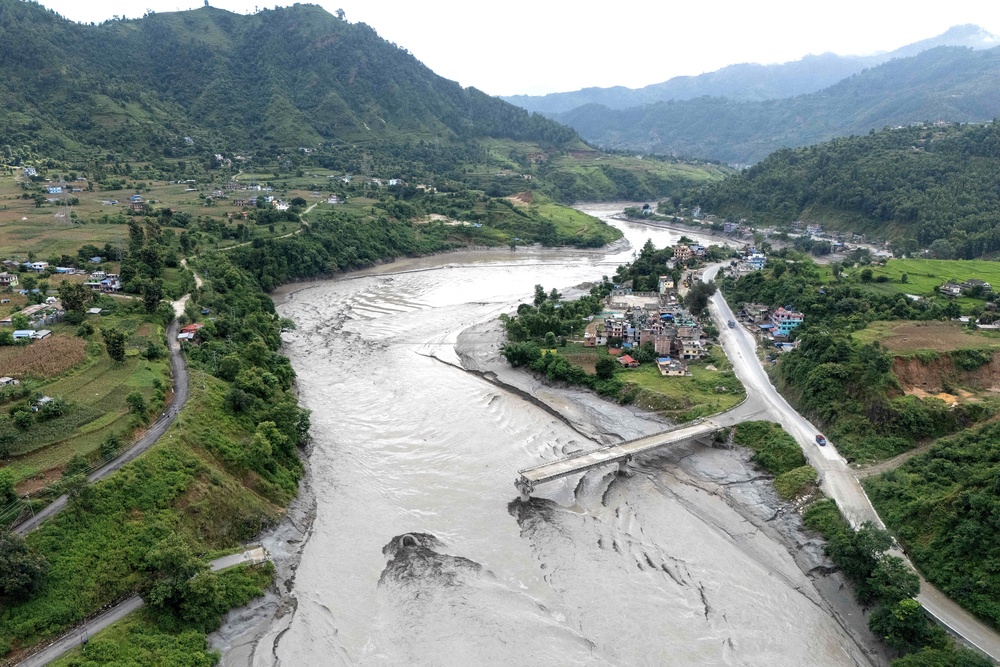 An aerial view shows the damaged Ghatbesi Bridge over the Trishuli River in the aftermath of flash floods in Nepal's Dhading district (AFP/Getty)