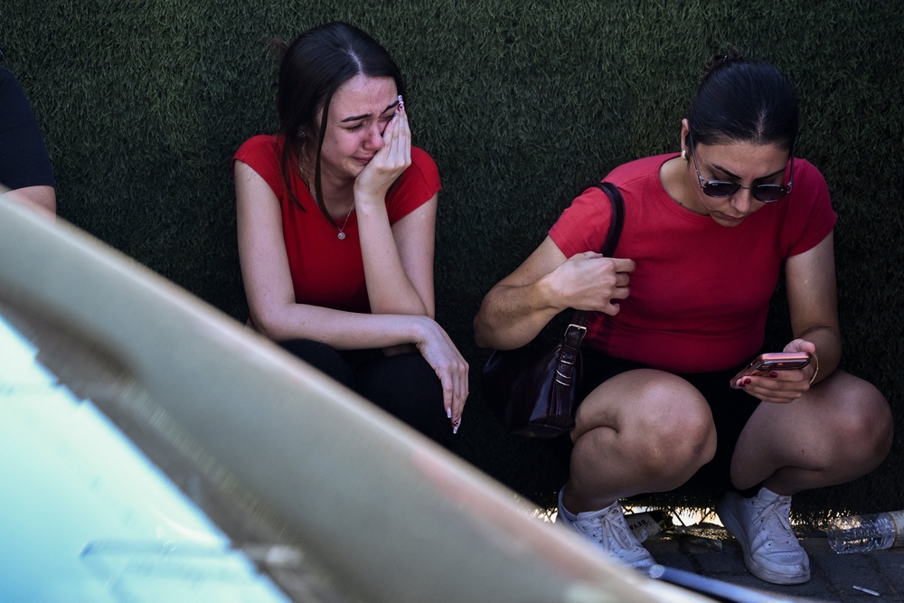 People react as they await news of their loved ones outside the port in Kyrenia, in the self-proclaimed Turkish Republic of Northern Cyprus (TRNC), recognised only by Turkey, on August 30, 2026, after a ferry capsized off the coast. (AFP/Getty)